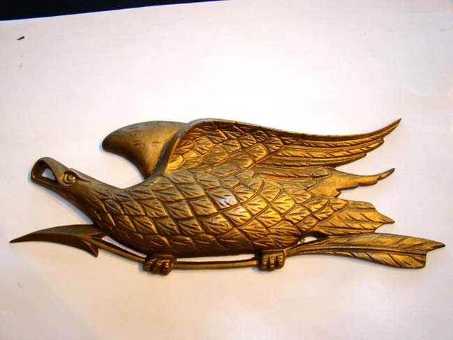 A vintage metal "BELLAMY" style American eagle plaque